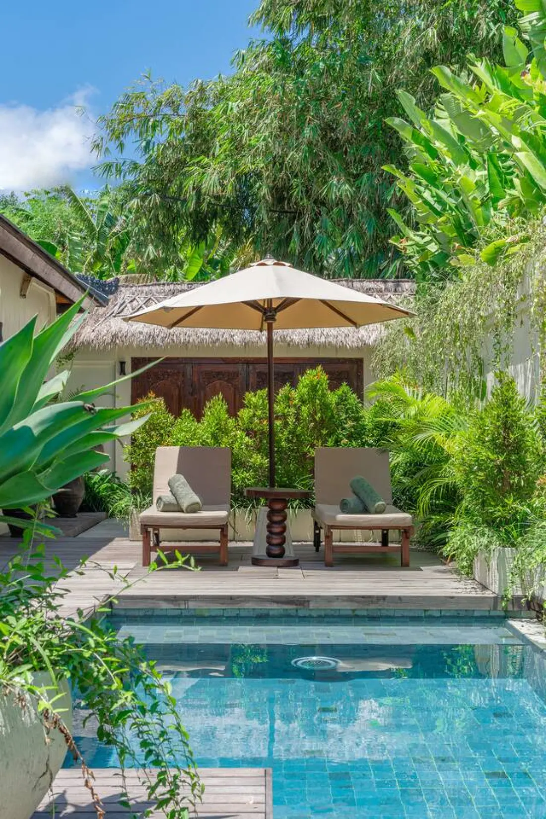 Poolside loungers and garden at Villa Club